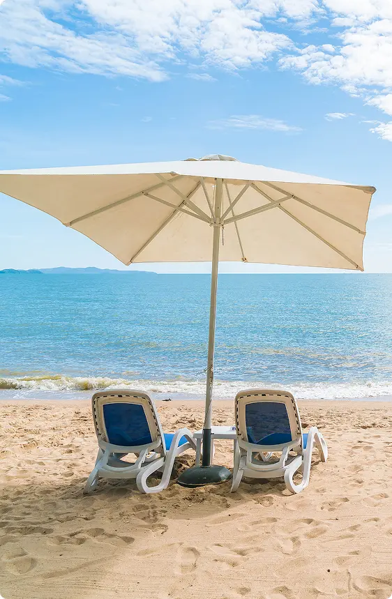 Beach loungers under umbrellas by the sea