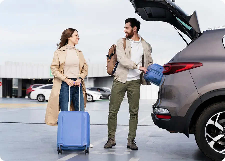 Couple with luggage at the airport transfer